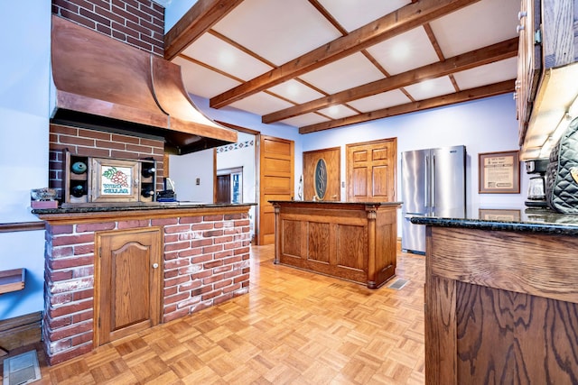 kitchen featuring kitchen peninsula, premium range hood, high end fridge, light parquet flooring, and a kitchen island