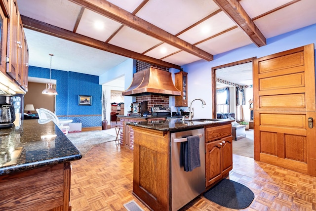 kitchen featuring stainless steel dishwasher, custom exhaust hood, sink, pendant lighting, and an island with sink