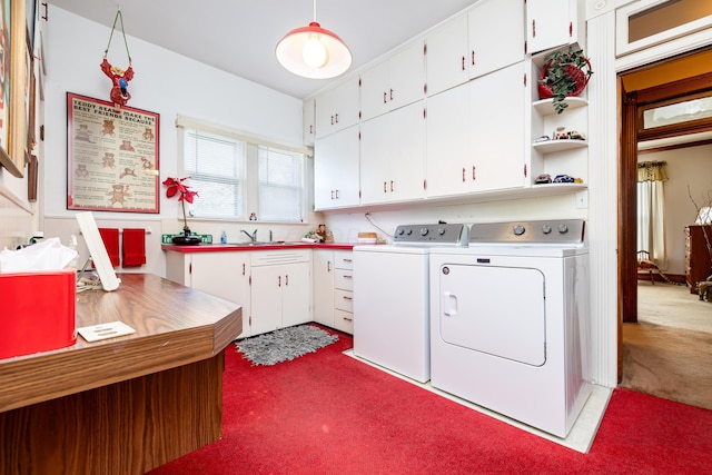 laundry area with cabinets, independent washer and dryer, carpet flooring, and sink