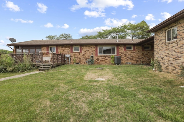 rear view of property with a lawn, a deck, and central air condition unit