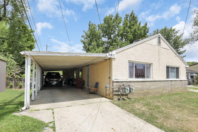 exterior space featuring a front yard and a carport