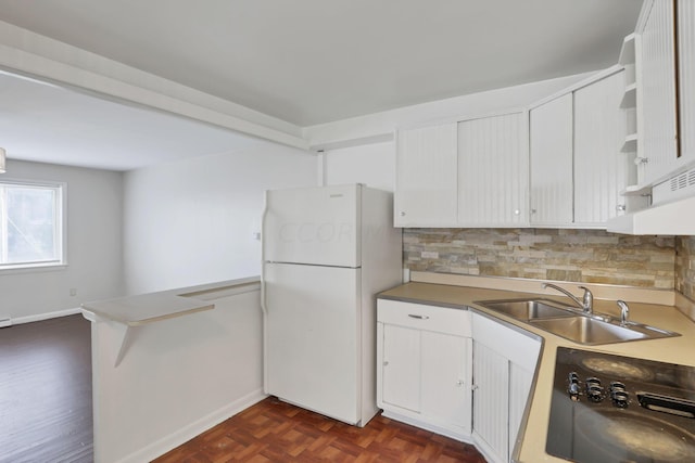 kitchen with decorative backsplash, sink, white refrigerator, white cabinets, and range