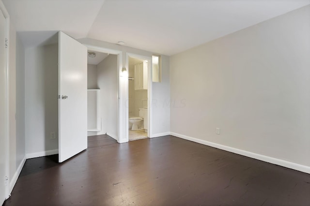 unfurnished room with dark hardwood / wood-style flooring