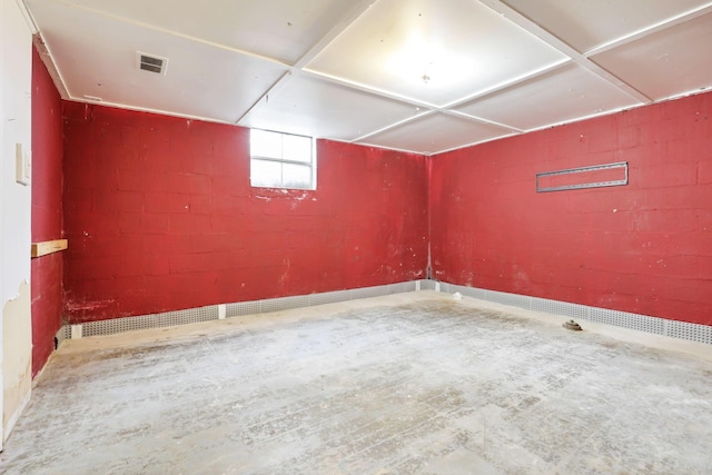 unfurnished room with concrete flooring