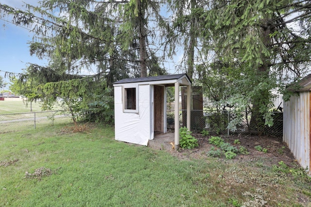 view of outbuilding featuring a lawn