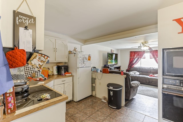 kitchen featuring black appliances, ceiling fan, and white cabinets