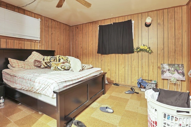 bedroom featuring wood walls and ceiling fan