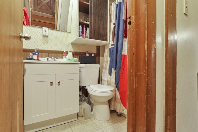 bathroom featuring decorative backsplash, vanity, and toilet