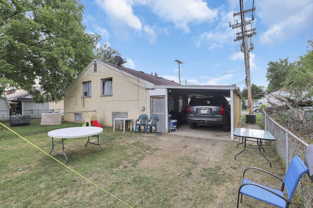 exterior space with a carport and a yard