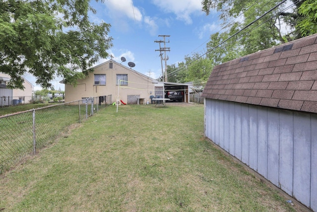 view of yard featuring an outbuilding and a carport