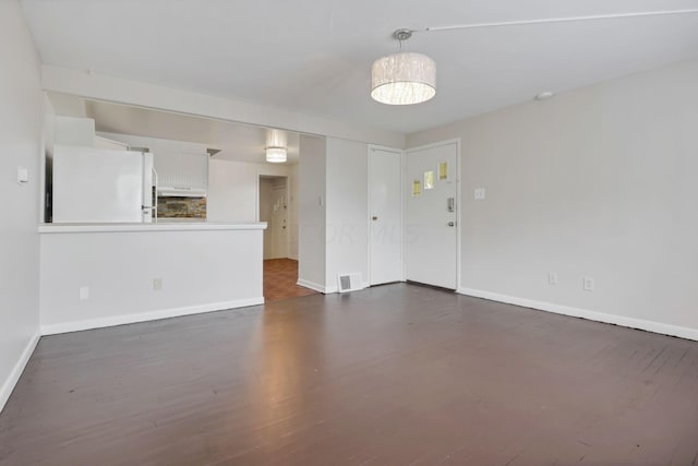 unfurnished living room featuring dark wood-type flooring