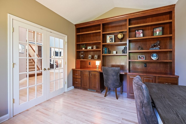 home office featuring french doors, light wood-type flooring, a textured ceiling, and vaulted ceiling