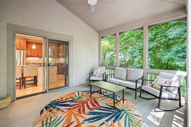 sunroom / solarium with ceiling fan and vaulted ceiling