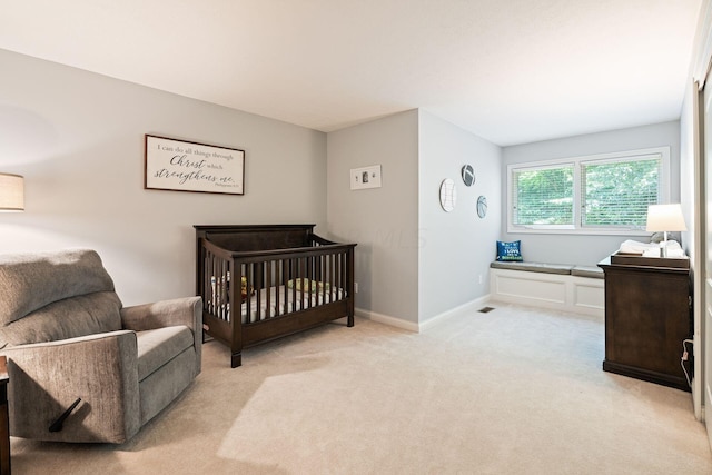 carpeted bedroom with a crib