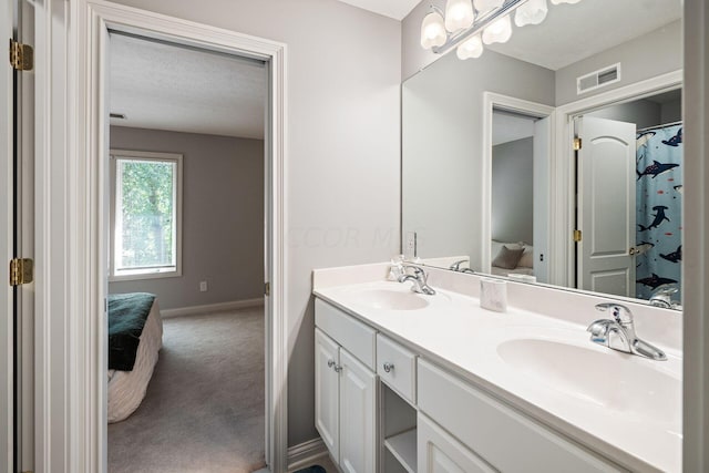 bathroom with vanity and a textured ceiling