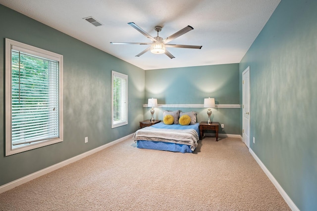 bedroom with ceiling fan and carpet floors