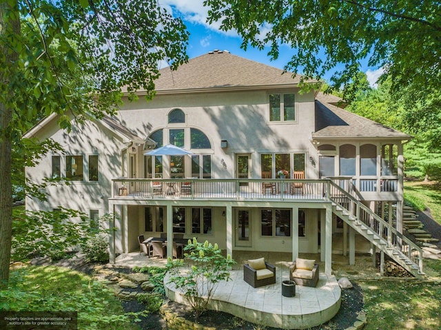 back of house featuring an outdoor living space, a deck, and a patio area