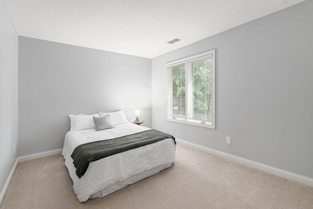 carpeted bedroom with a textured ceiling