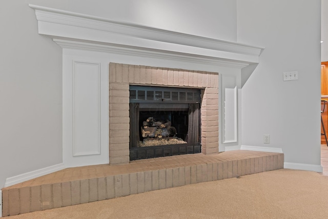 interior details with carpet flooring and a brick fireplace