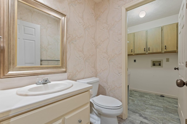 bathroom featuring vanity, toilet, and a textured ceiling