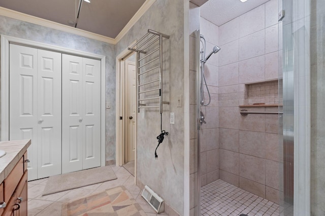 bathroom with tile patterned floors, vanity, ornamental molding, and a shower with door