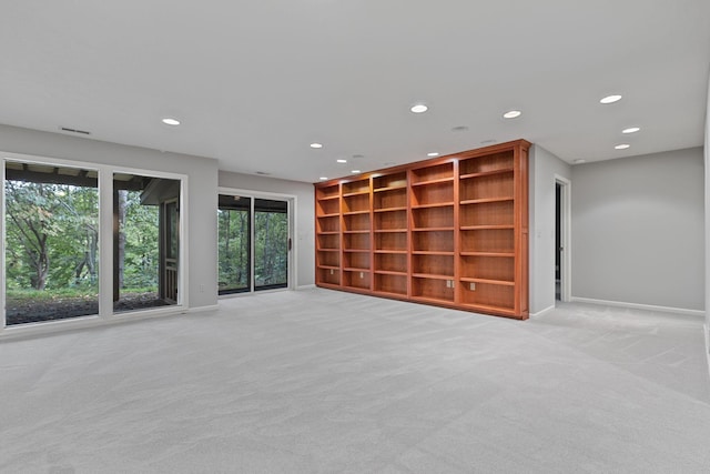 unfurnished living room featuring light colored carpet