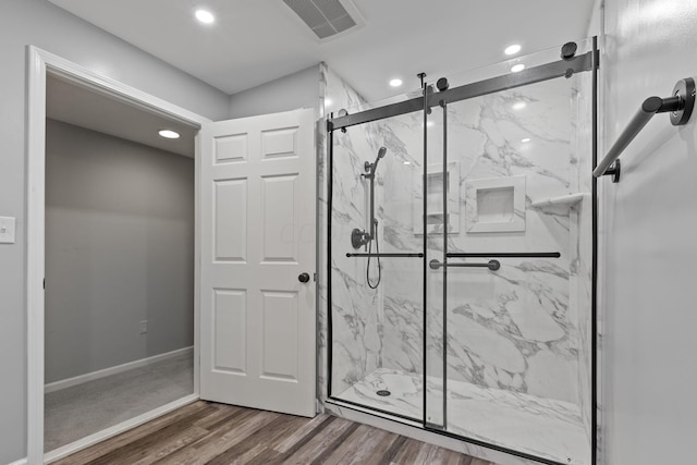 bathroom featuring wood-type flooring and walk in shower