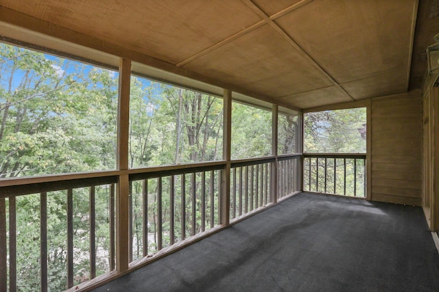 unfurnished sunroom with wooden ceiling