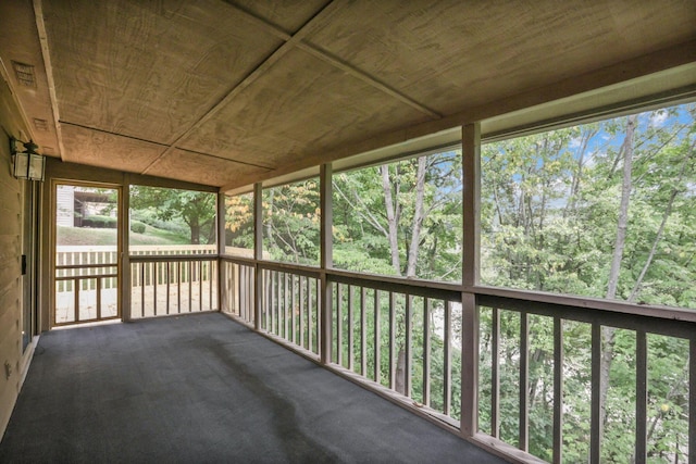 unfurnished sunroom featuring wooden ceiling and a healthy amount of sunlight