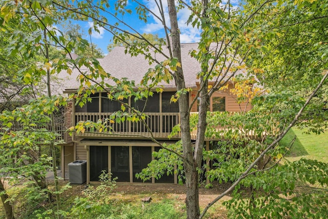 back of house with a sunroom and central AC