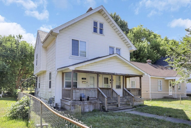 view of front of property with covered porch and a front yard