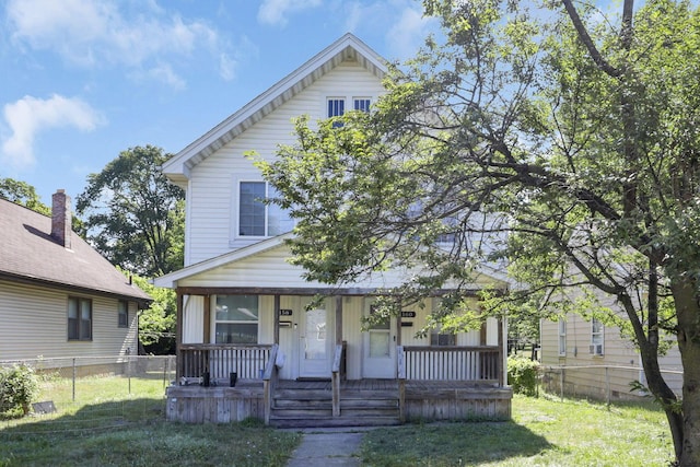 bungalow-style house featuring a porch and a front yard