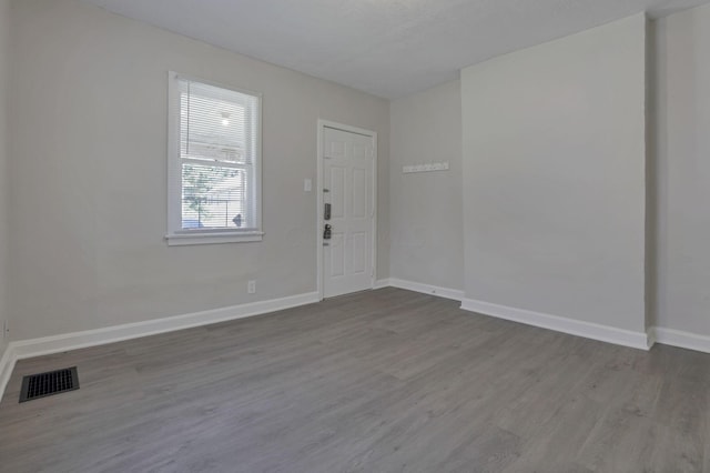 unfurnished room featuring hardwood / wood-style flooring