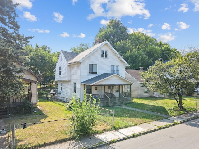 view of front of house featuring covered porch and a front lawn