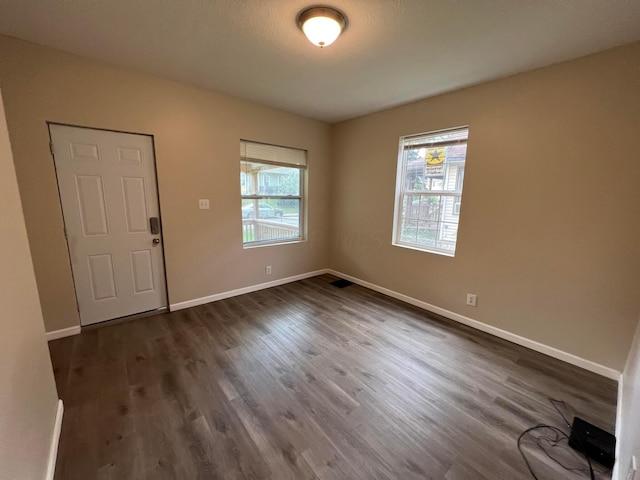 unfurnished room with dark hardwood / wood-style floors