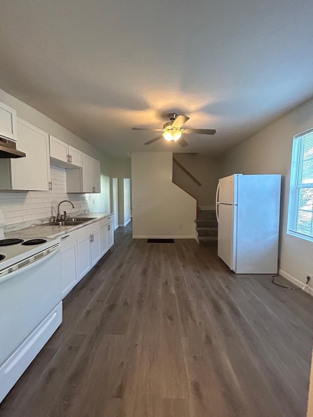 kitchen featuring dark hardwood / wood-style flooring, tasteful backsplash, white appliances, sink, and white cabinets