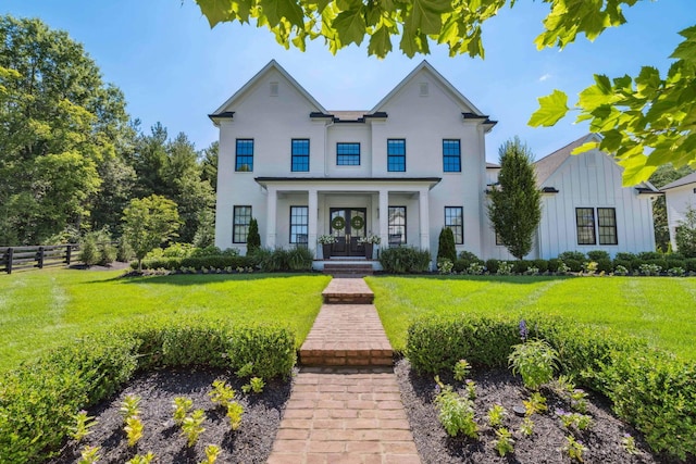 view of front of home featuring covered porch and a front lawn