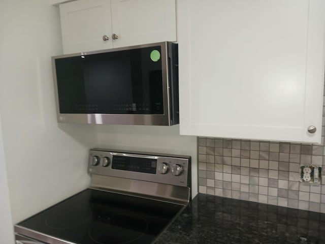 kitchen featuring white cabinetry, backsplash, and appliances with stainless steel finishes