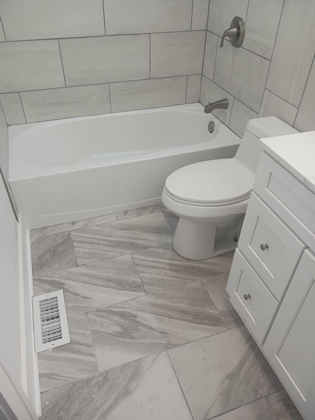 full bathroom featuring vanity, toilet, and tiled shower / bath combo