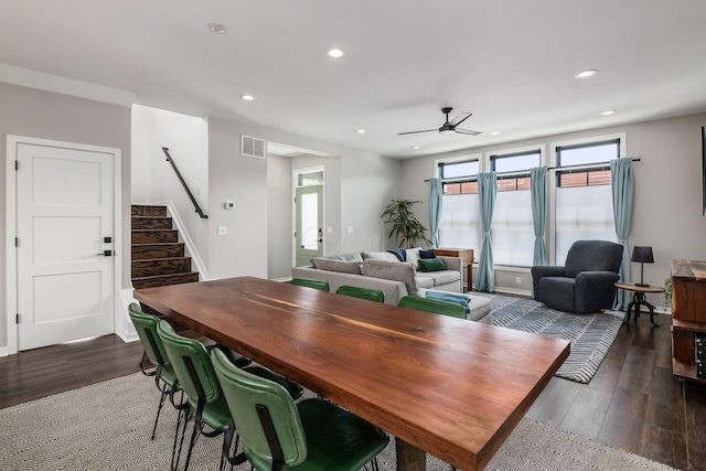 dining area with ceiling fan and dark hardwood / wood-style floors