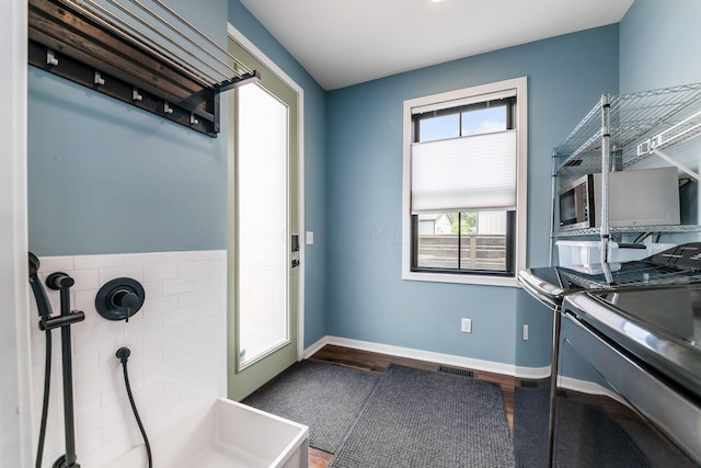 doorway to outside featuring hardwood / wood-style floors and independent washer and dryer