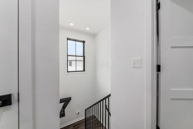 stairway with hardwood / wood-style flooring