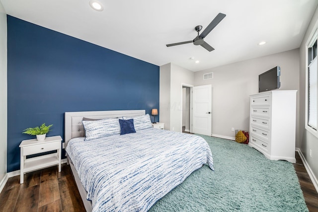 bedroom featuring ceiling fan and dark hardwood / wood-style floors