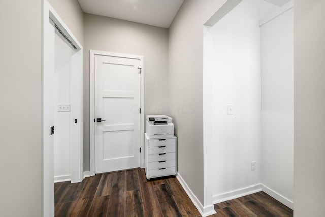 hallway with dark hardwood / wood-style flooring