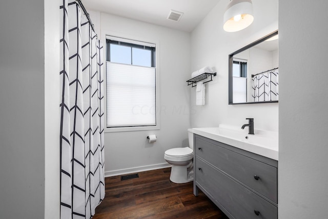 bathroom featuring a shower with curtain, hardwood / wood-style floors, vanity, and toilet