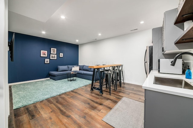 living room featuring dark hardwood / wood-style floors and sink