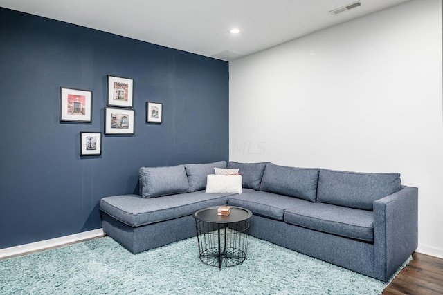 living room with dark hardwood / wood-style flooring