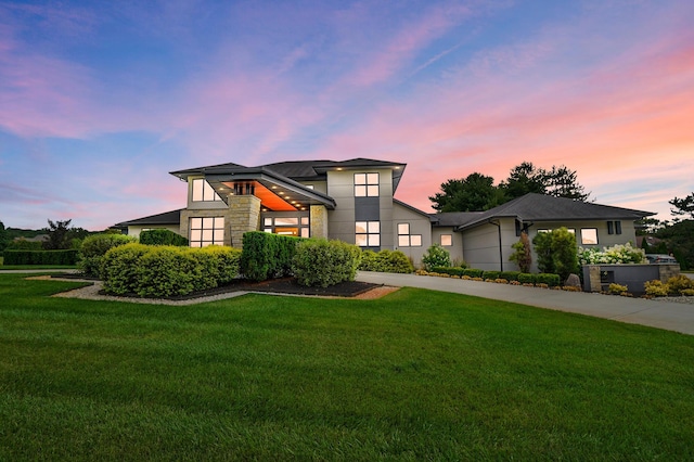 view of front of property with a yard and a garage