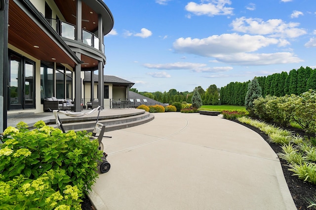 view of community featuring an outdoor hangout area and a patio