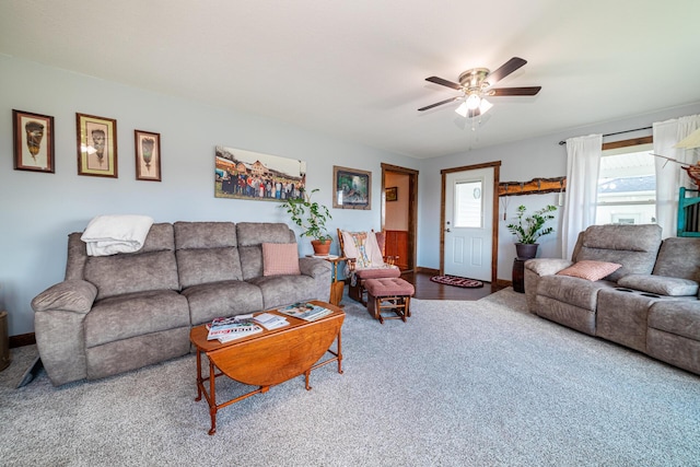 carpeted living room with ceiling fan